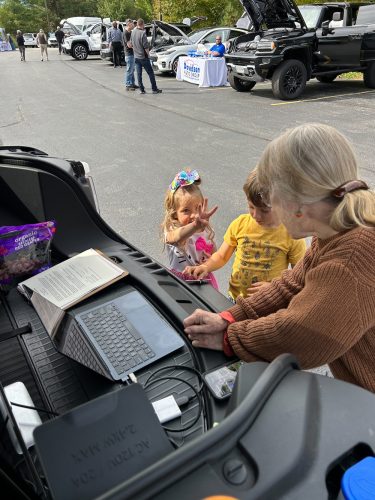 Children learn about electric cars at the 2024 North Country Drive Electric event at The Wild Center.